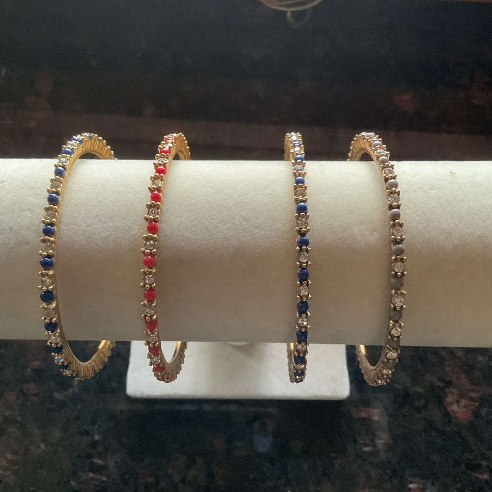 J. Crew  Gold Plated Bangle with Red, Blue, Grey and Clear Accents. Set of 4.